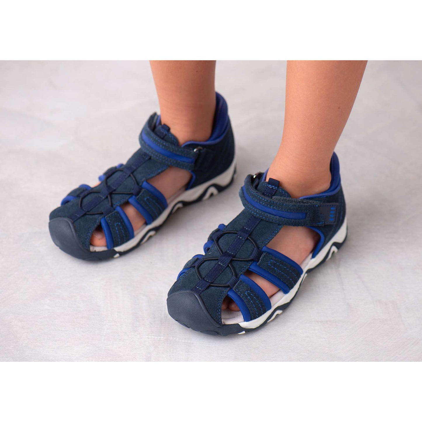 Stylish dark blue orthotic sandals for correct foot arch development