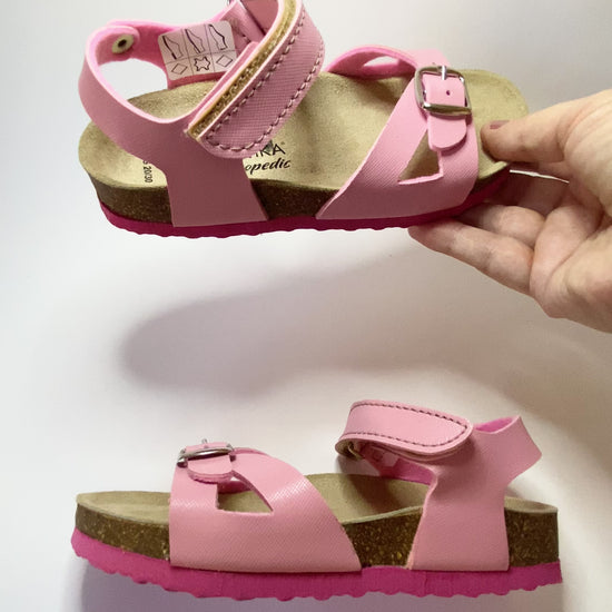 A presentation of pink orthotic sandals for older girls, from Protetika brand.