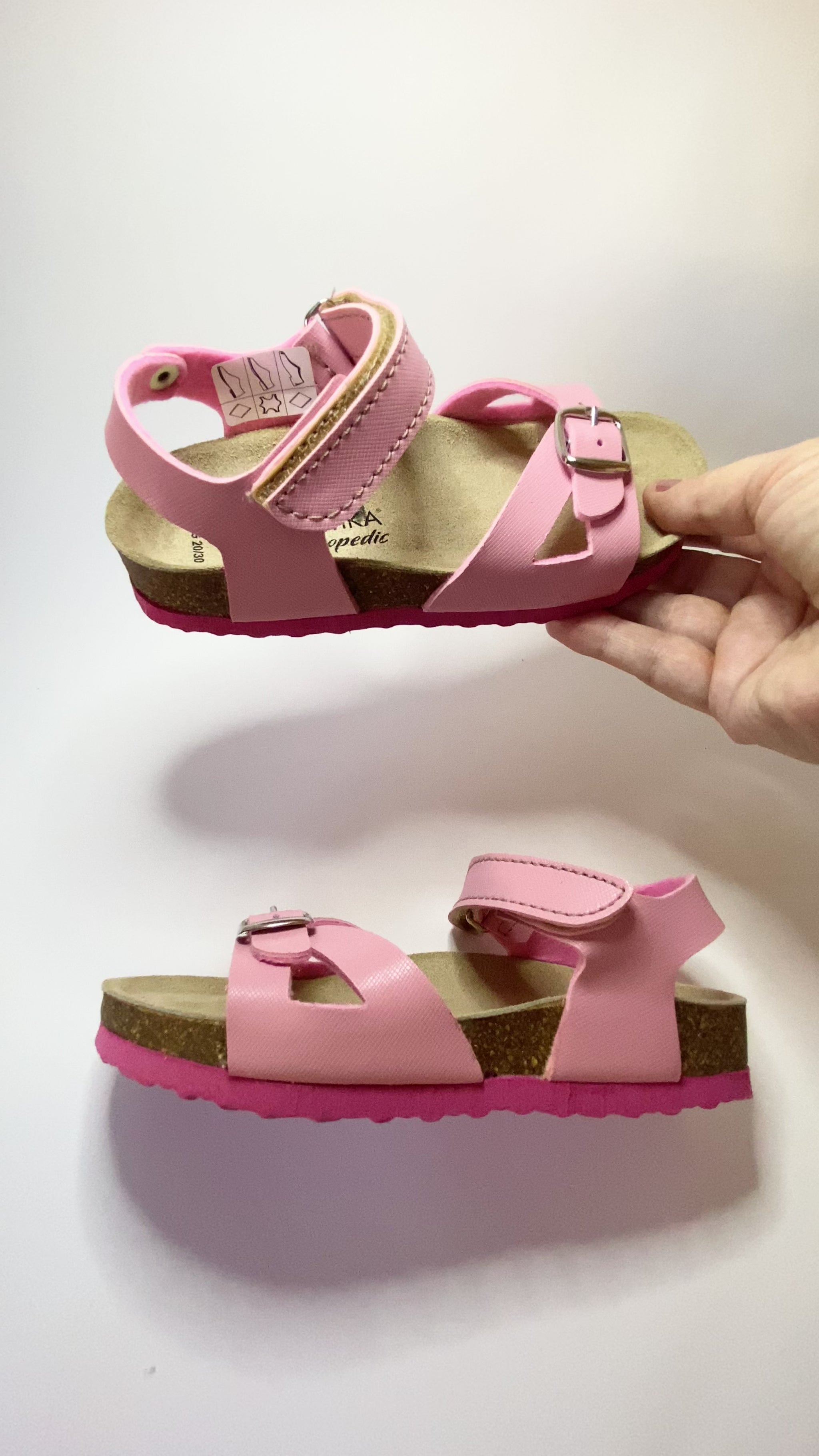 A presentation of pink orthotic sandals for older girls, from Protetika brand.