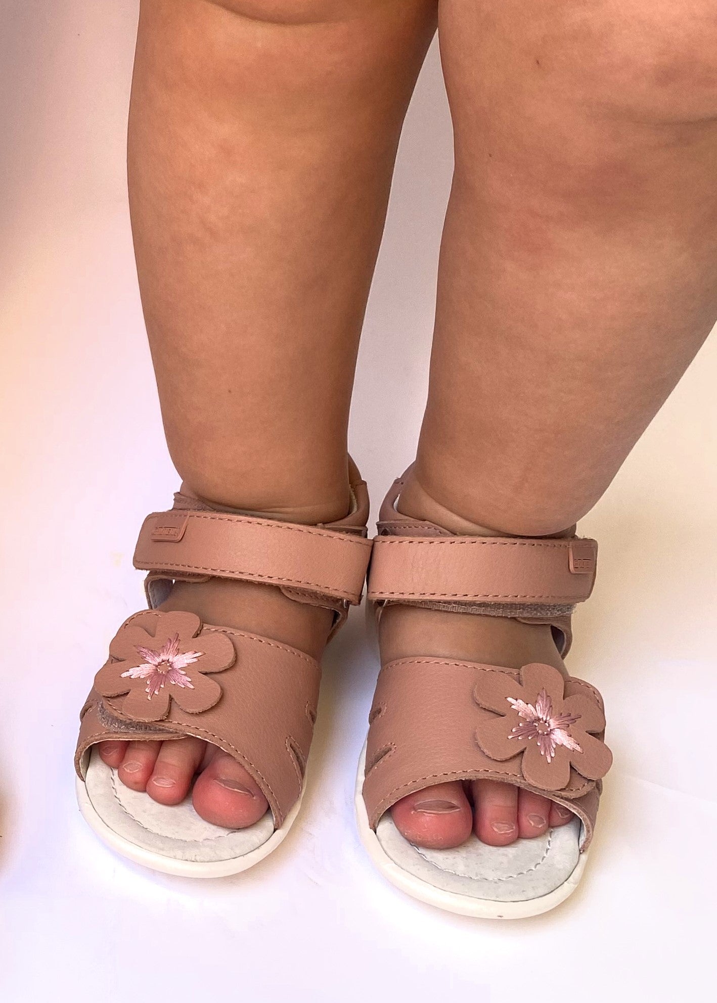PRIA pink is an arch supporting sandal for toddler girls, in a beautiful peachy pink neutral colour and a beautiful decorative flower.